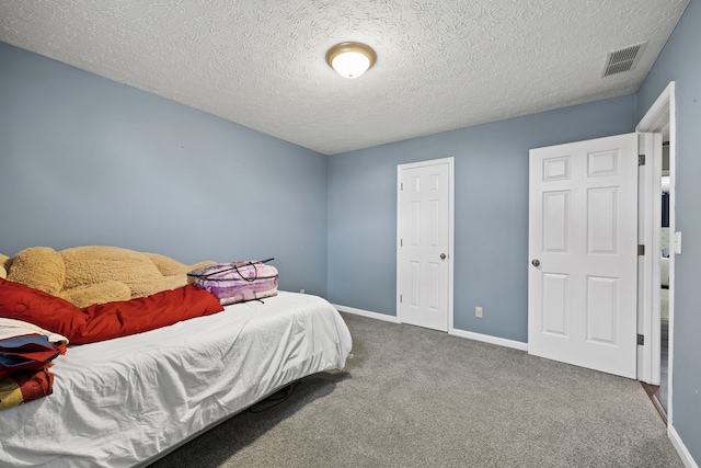 carpeted bedroom featuring a textured ceiling