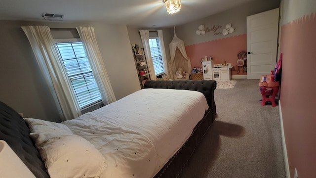 carpeted bedroom featuring multiple windows