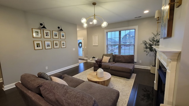 living room featuring dark wood-type flooring and a notable chandelier