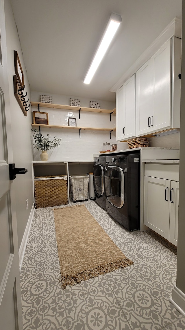 washroom with washer and clothes dryer and cabinets