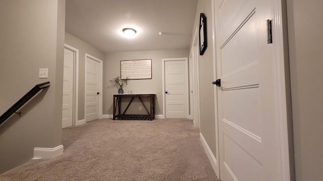 hallway featuring light carpet