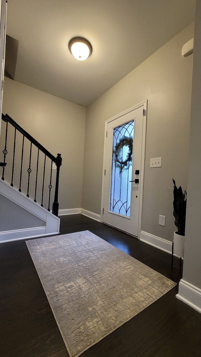 foyer entrance with dark hardwood / wood-style flooring