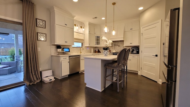 kitchen featuring white cabinets, appliances with stainless steel finishes, and a kitchen island