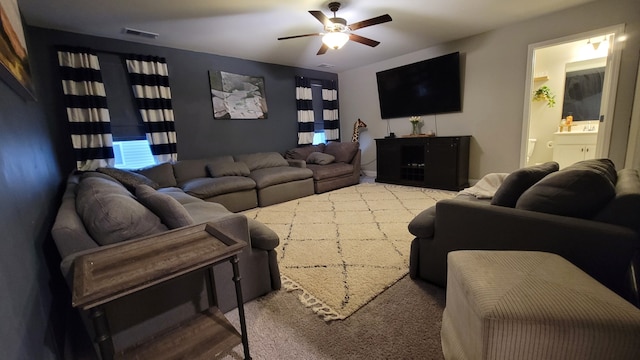 carpeted living room featuring ceiling fan