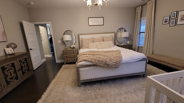 bedroom with an inviting chandelier and hardwood / wood-style flooring