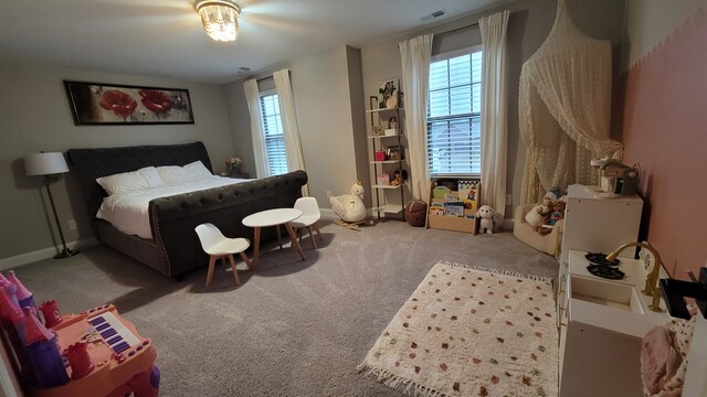 bedroom with multiple windows and carpet