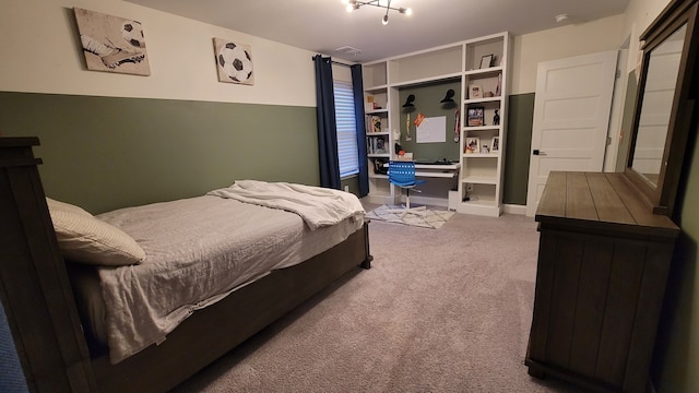 bedroom featuring carpet floors and built in desk