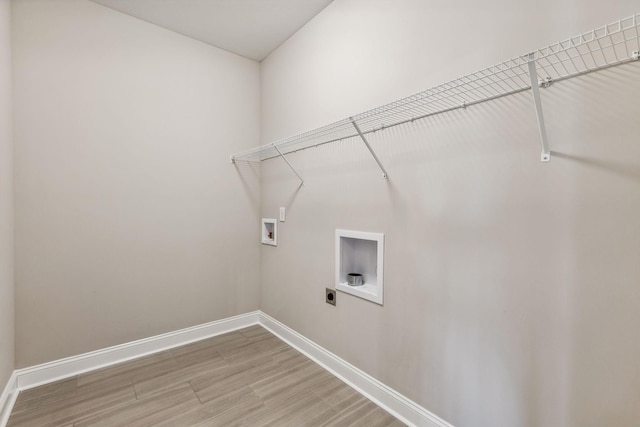 laundry area featuring washer hookup, electric dryer hookup, and hardwood / wood-style floors