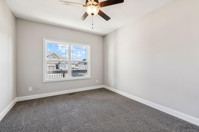 carpeted spare room with ceiling fan