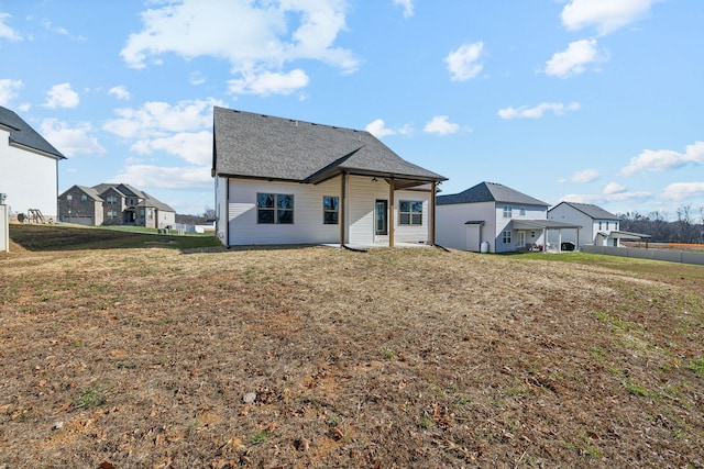 back of house featuring a lawn