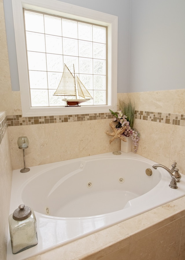 bathroom with tiled bath