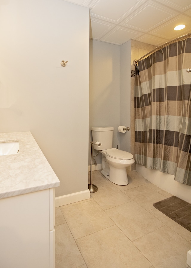 full bathroom with tile patterned flooring, vanity, toilet, and shower / bath combo with shower curtain