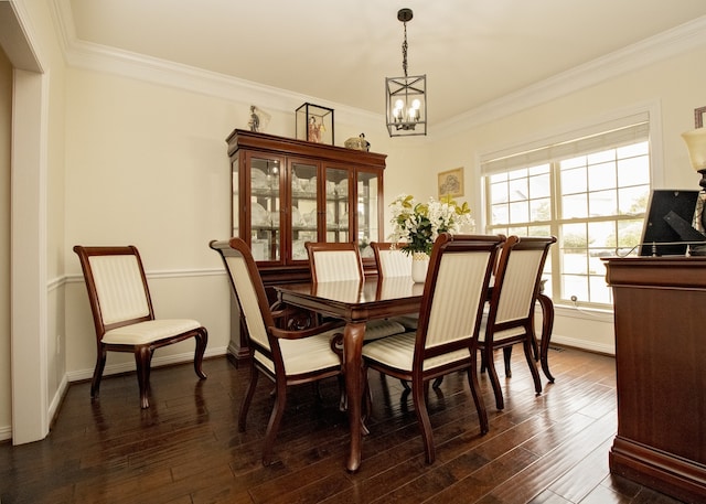 dining room featuring dark hardwood / wood-style floors, ornamental molding, and an inviting chandelier