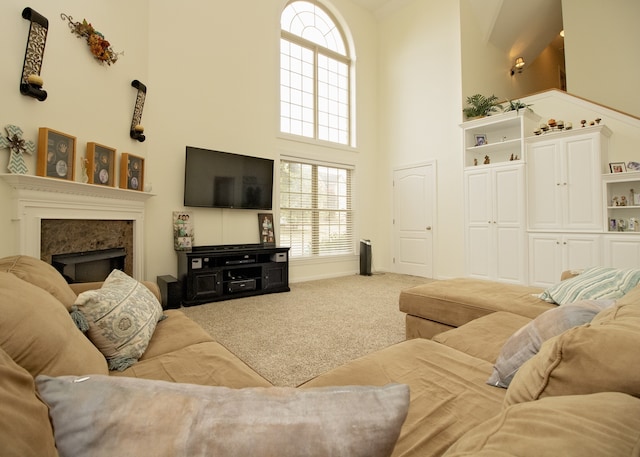 carpeted living room featuring a towering ceiling and a wealth of natural light