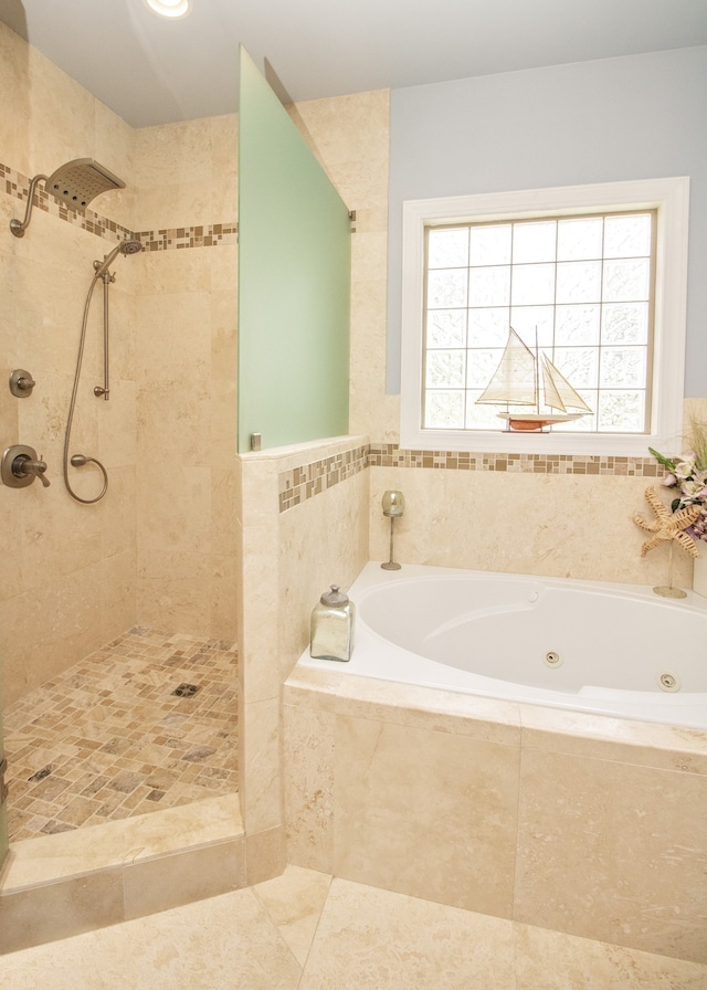 bathroom with plenty of natural light and shower with separate bathtub