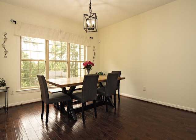 dining area featuring a chandelier and dark hardwood / wood-style floors