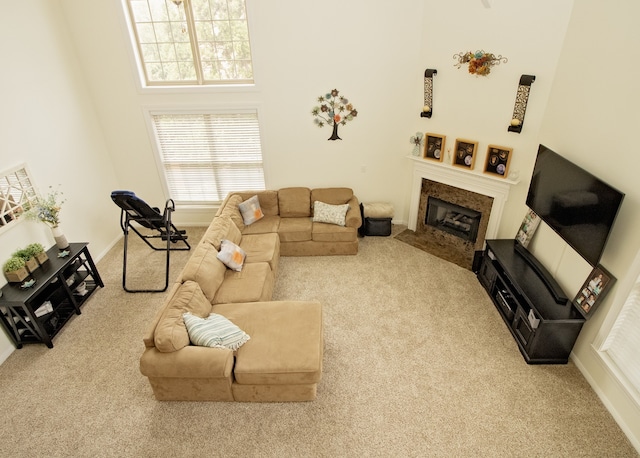 living room with light carpet and a high ceiling