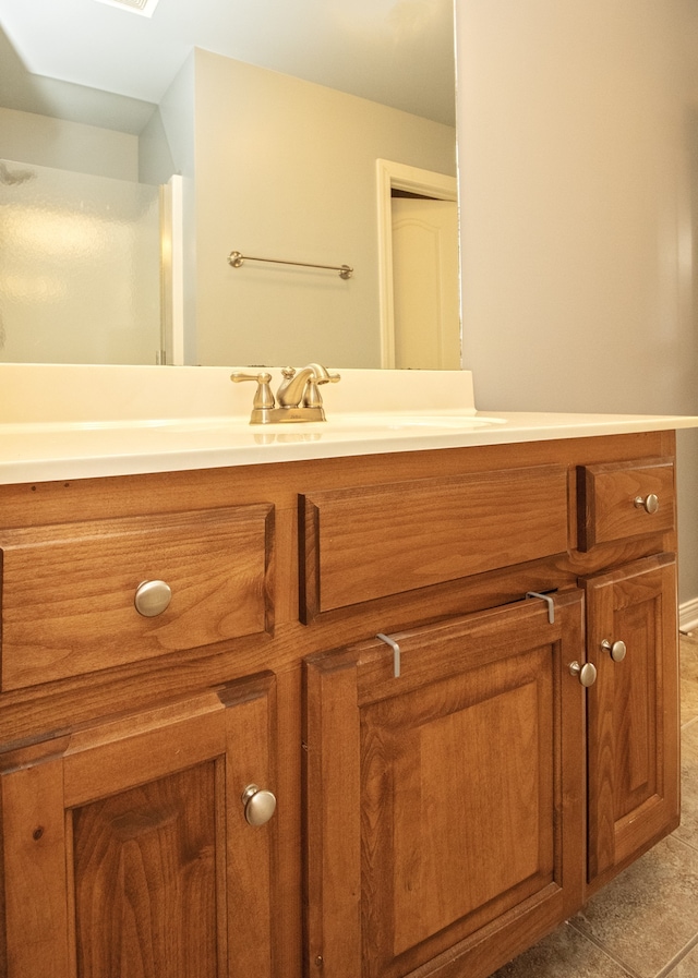 bathroom with tile patterned flooring and vanity