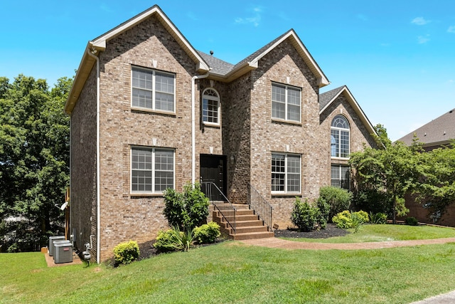 front facade with cooling unit and a front yard