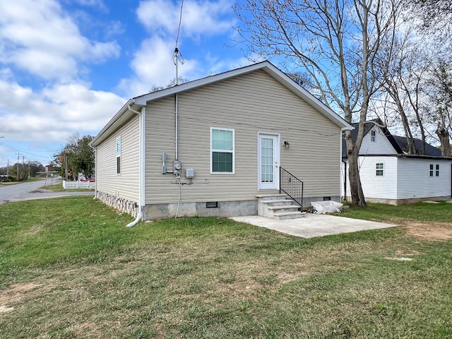 back of house with a yard and a patio area