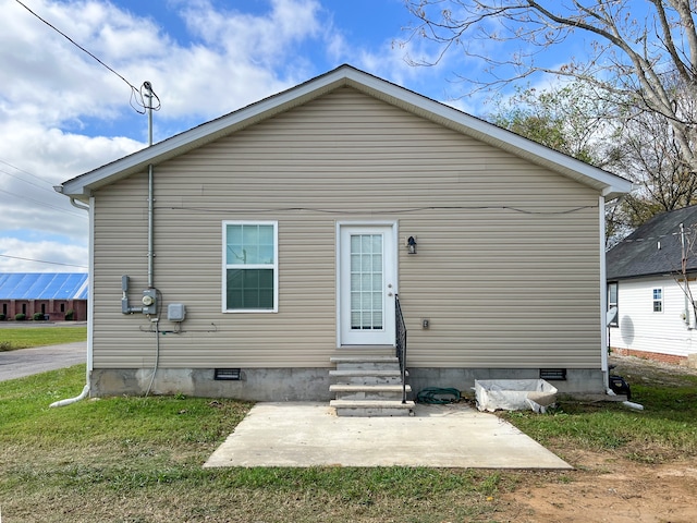 back of property with a patio