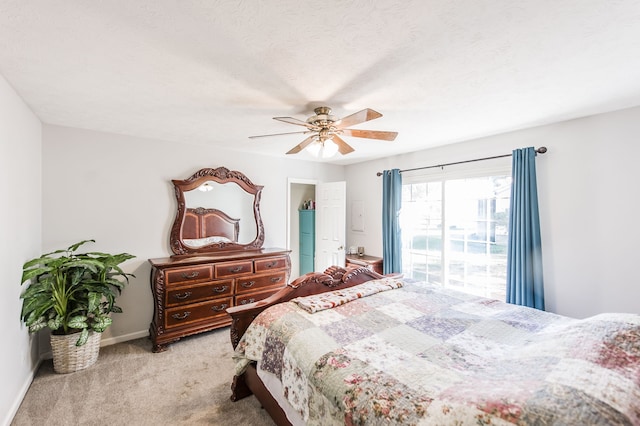 carpeted bedroom with a textured ceiling and ceiling fan