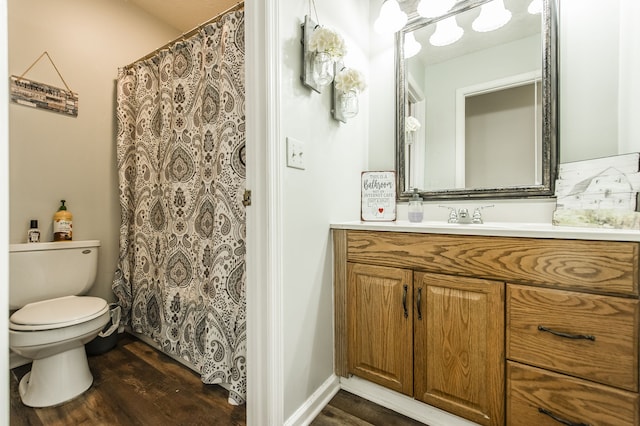 bathroom with hardwood / wood-style floors, vanity, and toilet