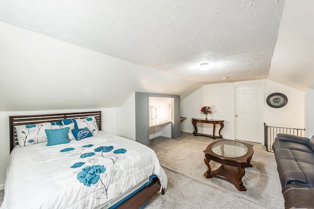 bedroom with carpet, vaulted ceiling, and a textured ceiling