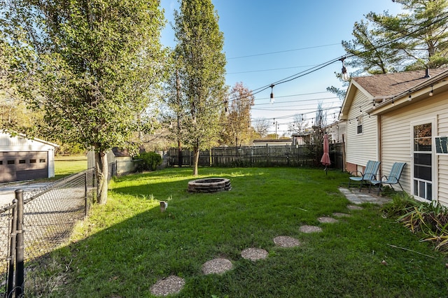 view of yard with a fire pit