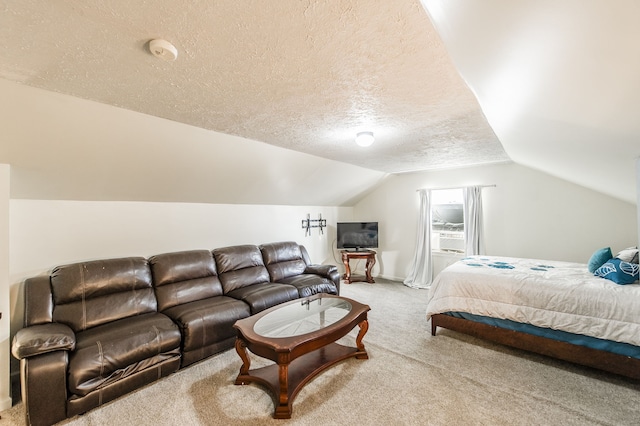 carpeted bedroom featuring lofted ceiling and a textured ceiling