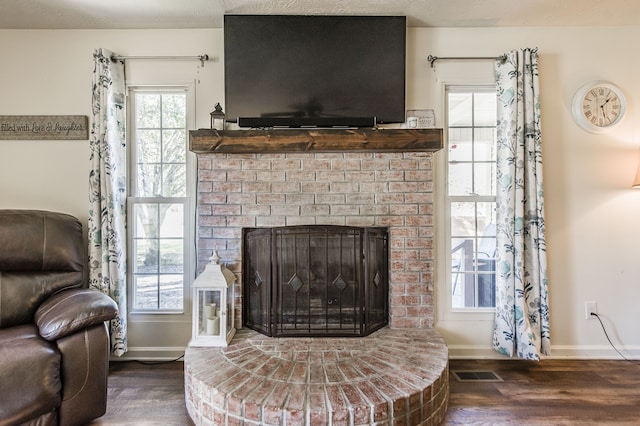 interior space with dark wood-type flooring and a fireplace