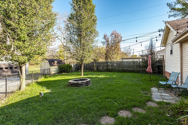 view of yard with an outdoor fire pit