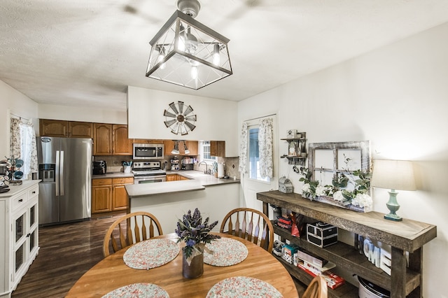 dining space featuring dark hardwood / wood-style floors and sink