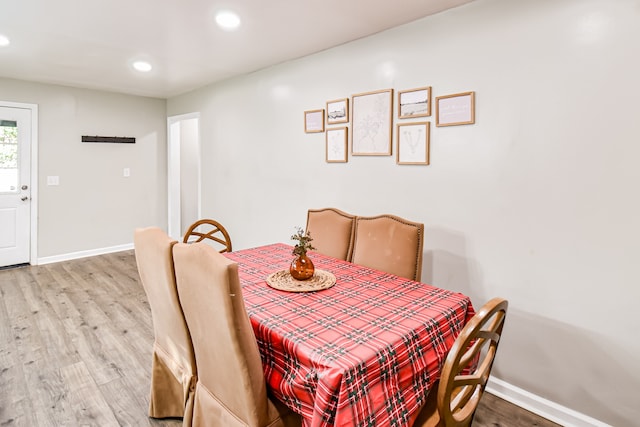 dining space with wood-type flooring