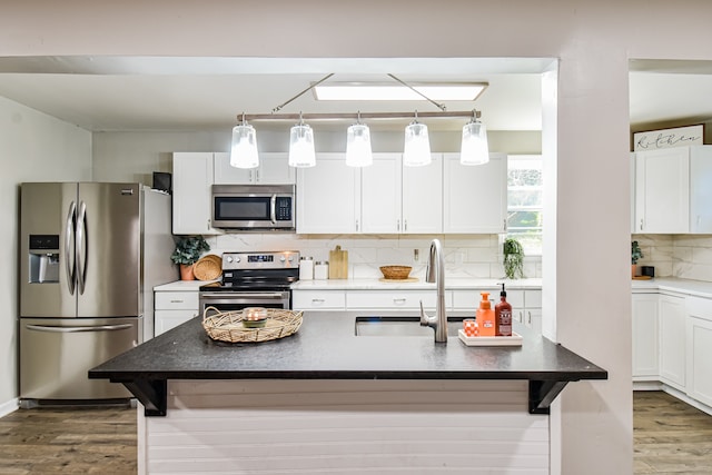 kitchen featuring white cabinets, a kitchen breakfast bar, and stainless steel appliances