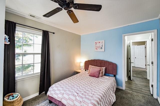 bedroom featuring ceiling fan, dark hardwood / wood-style flooring, and ornamental molding