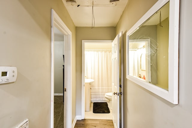 hall featuring light hardwood / wood-style floors and a baseboard heating unit