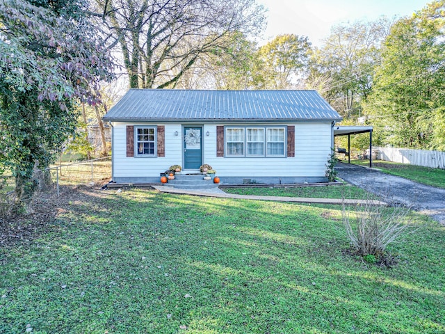 view of front facade with a front lawn and a carport