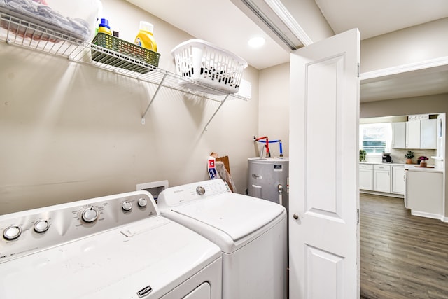 clothes washing area with water heater, washing machine and dryer, and dark wood-type flooring