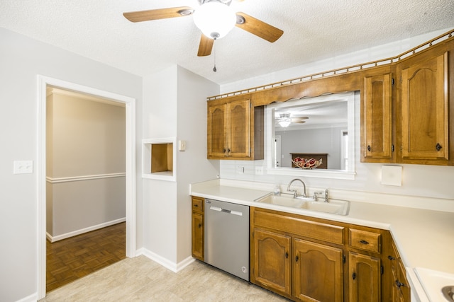 kitchen with a textured ceiling, sink, light parquet floors, and dishwasher