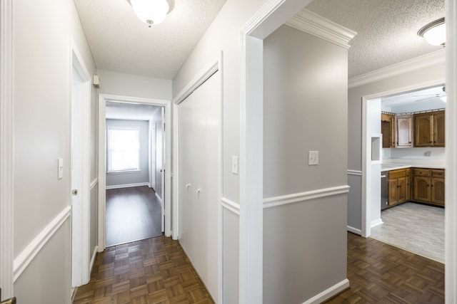 hallway featuring dark parquet flooring, a textured ceiling, and crown molding