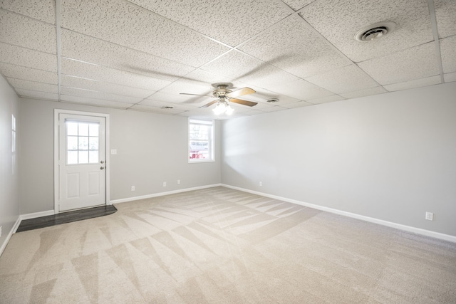 spare room with a drop ceiling, ceiling fan, and plenty of natural light