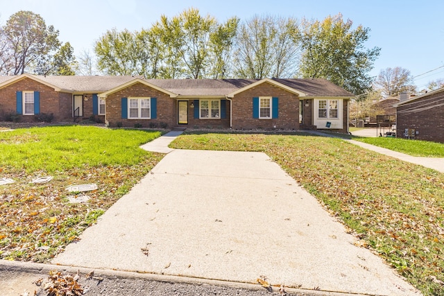 ranch-style home with a front lawn