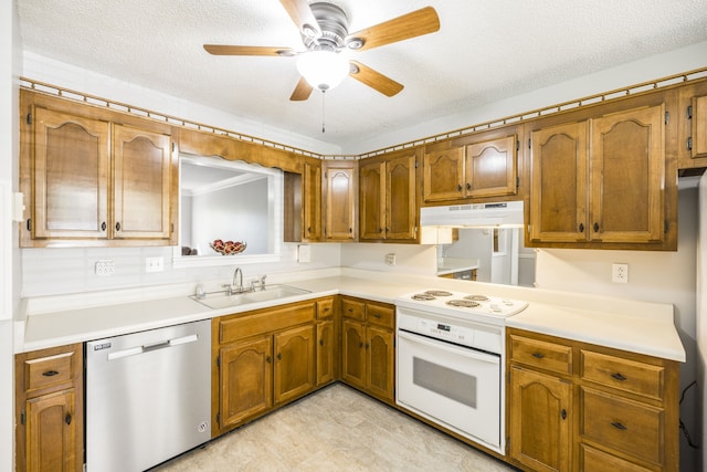 kitchen with white appliances, sink, ceiling fan, and a textured ceiling