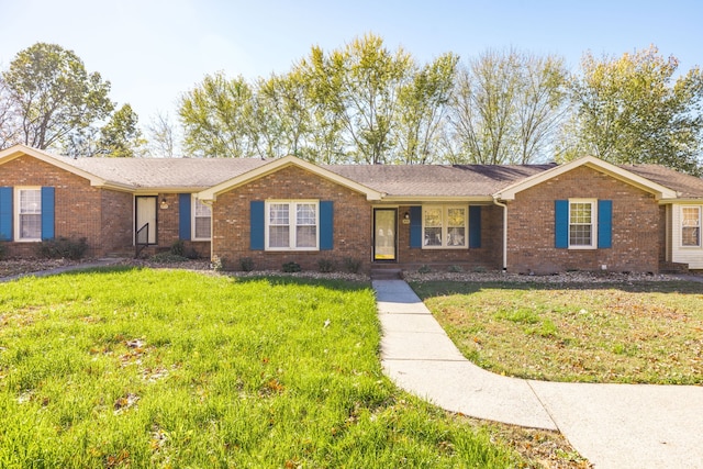 single story home with a front lawn