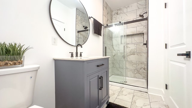 bathroom featuring walk in shower, vanity, and toilet