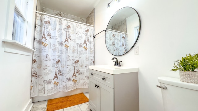 bathroom featuring toilet and vanity