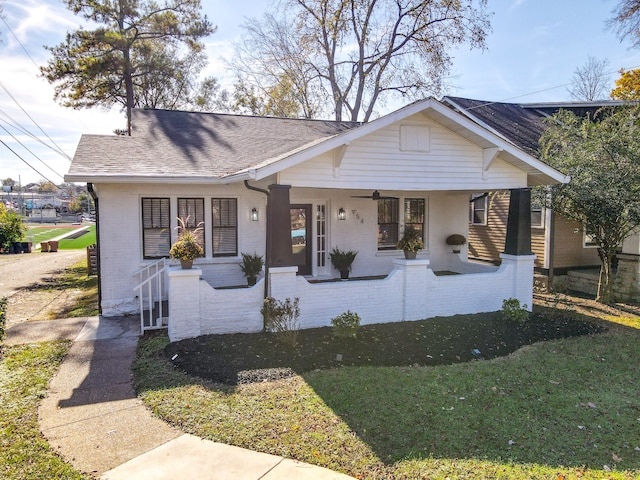 bungalow featuring a porch and a front lawn