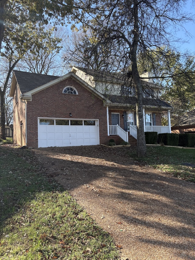 ranch-style home with a garage and covered porch