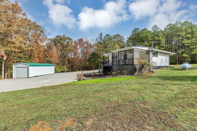 view of yard featuring an outdoor structure and a wooden deck